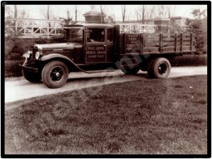International Trucks Collectible Metal Sign: Paul Leppo Hauling Stakebed Truck