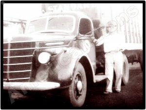 International Trucks Collectible Metal Sign: Vintage Truck & Driver - Image 1